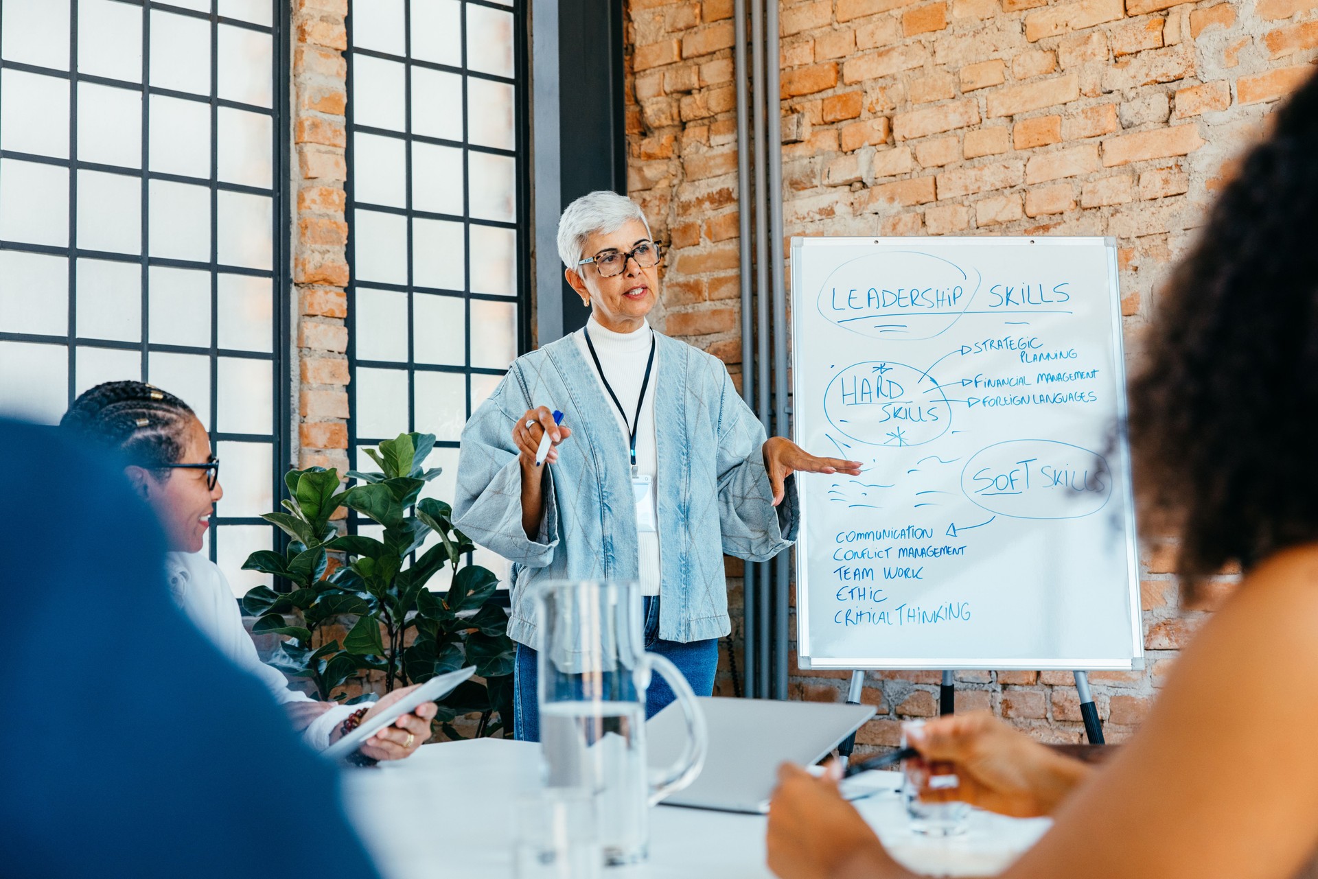 Mature businesswoman presenting a strategy on leadership skills in a fresh and innovative office setting